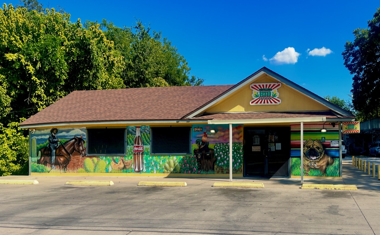 The full Tortilleria Rio storefront, with its colorful murals and signs